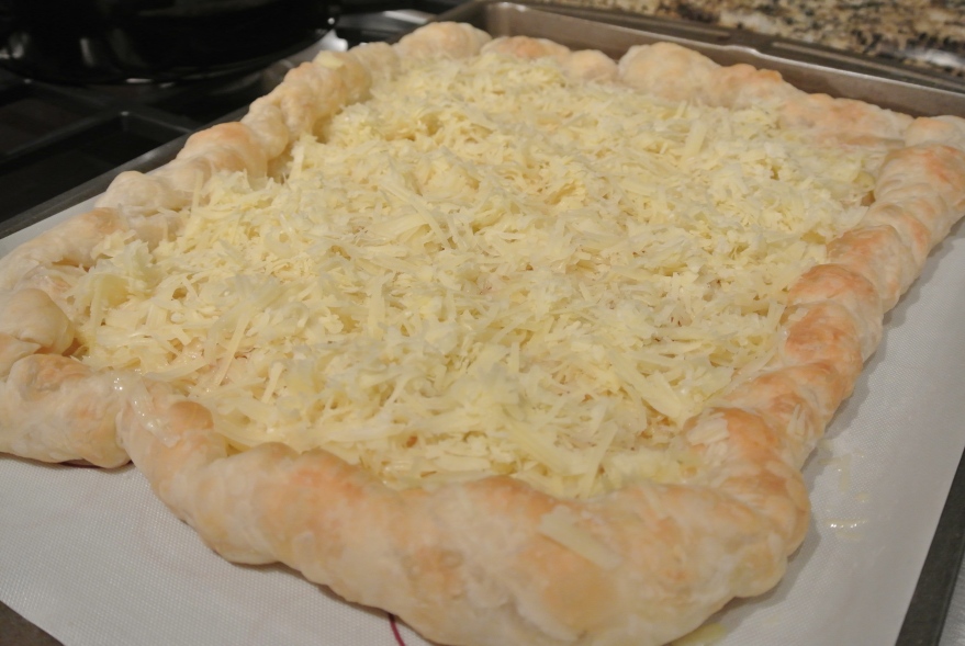 Shredded Gruyere on puff pastry